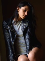 Antoinette exudes a lusty swagger wearing a black leather jacket and an intense gaze in her eyes.